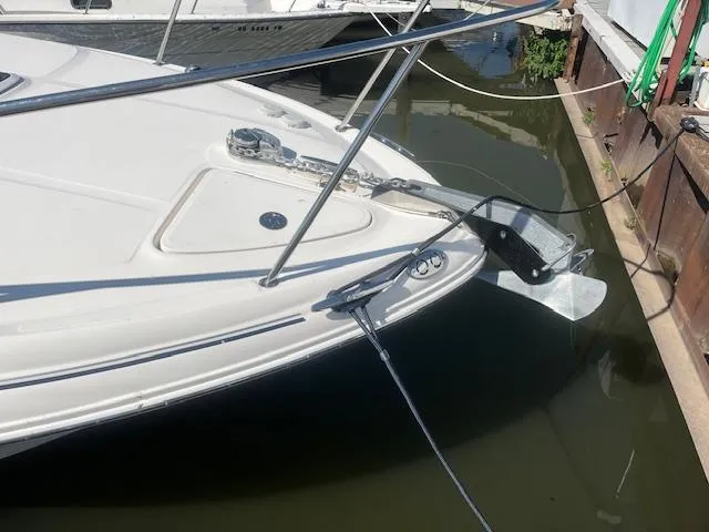 Slide: The Image of 2005 Sea Ray 280 Sundancer boat docked, showing anchor and bow details. - 7