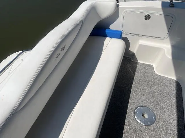 Slide: The Image of 2005 Sea Ray 280 Sundancer boat interior with white seating and grey carpet. - 9