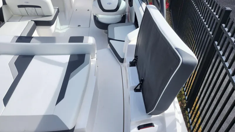 Slide: The Image of 2025 Regal 21 OBX boat interior with sleek white and gray seating design. - 10