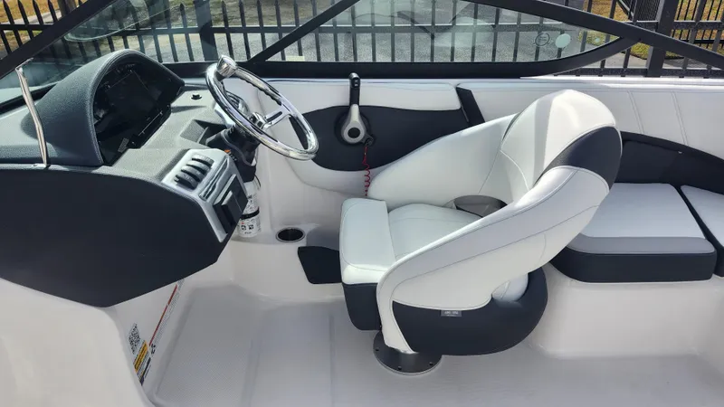 Slide: The Image of 2025 Regal 21 OBX boat storage compartment with cushioned seating. - 14