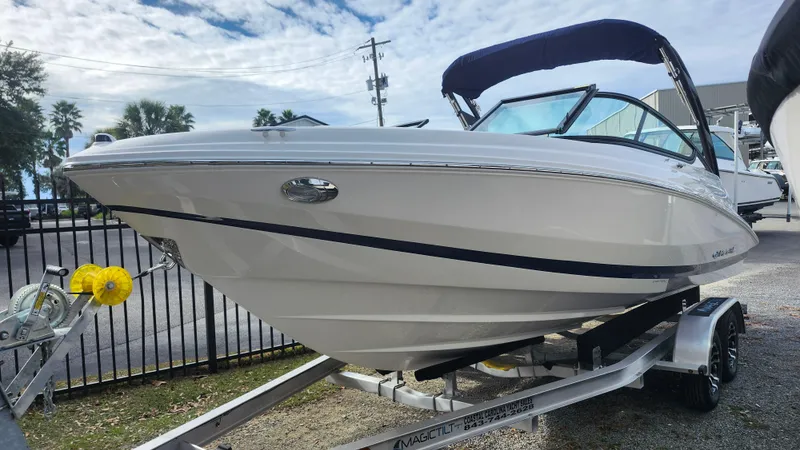 Slide: The Image of 2025 Regal 21 OBX boat on trailer, sleek design, outdoor setting. - 2