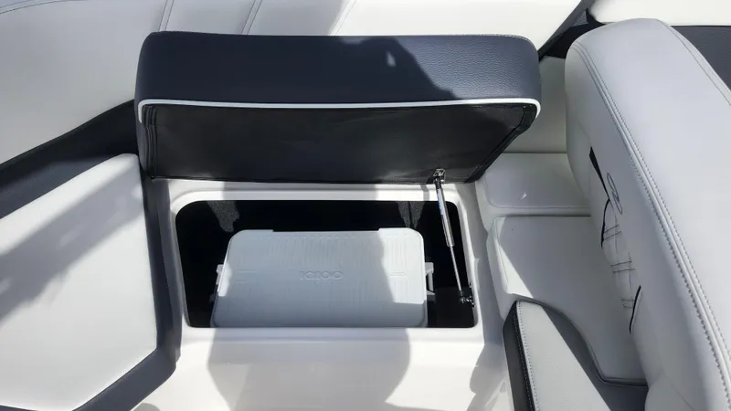 Slide: The Image of 2025 Regal 21 OBX boat storage compartment with open seat and interior view. - 20