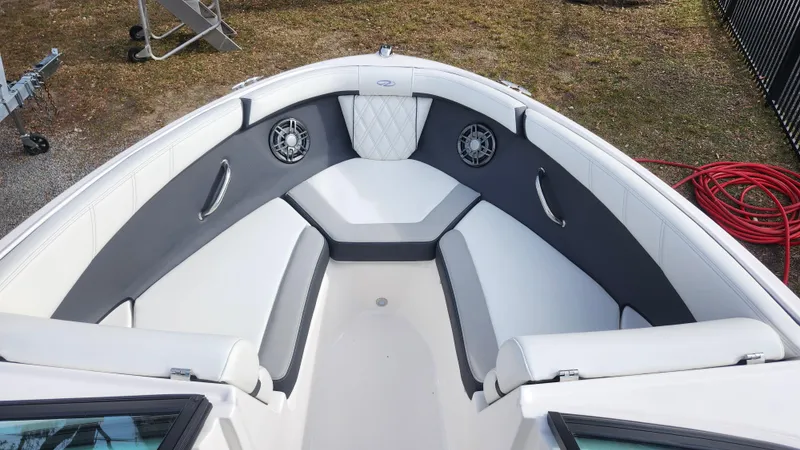 Slide: The Image of 2025 Regal 21 OBX boat seat storage compartment with open lid. - 21