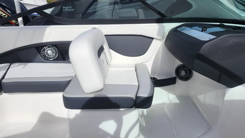 Slide: The Image of 2025 Regal 21 OBX boat interior with sleek seating and modern dashboard. - 26