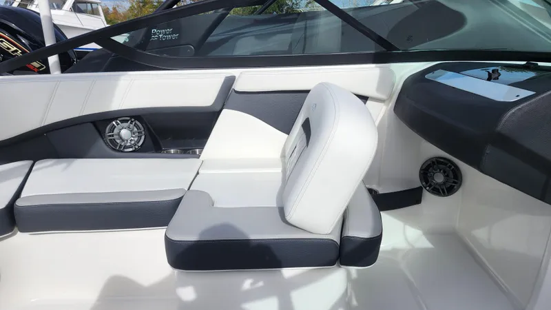Slide: The Image of 2025 Regal 21 OBX boat interior with sleek seating and control panel. - 27