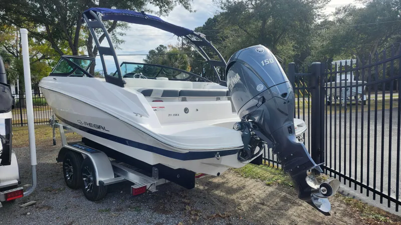 Slide: The Image of 2025 Regal 21 OBX boat with outboard motor on a trailer. - 3