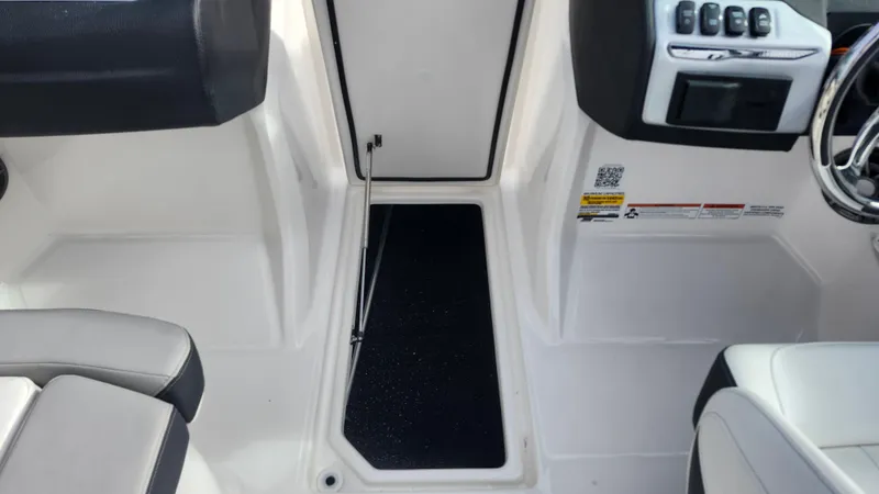 Slide: The Image of 2025 Regal 21 OBX boat with canopy, parked in a marina. - 33