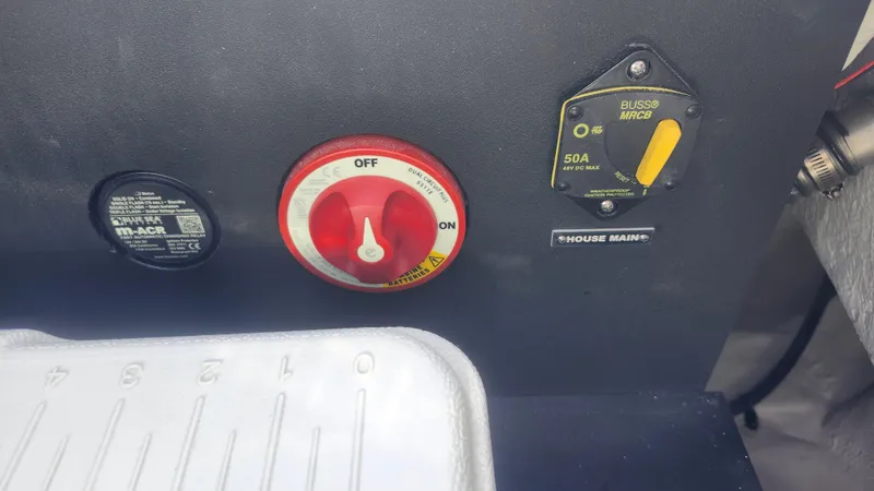 Slide: The Image of 2025 Regal 21 OBX boat control panel with switches and battery selector. - 7