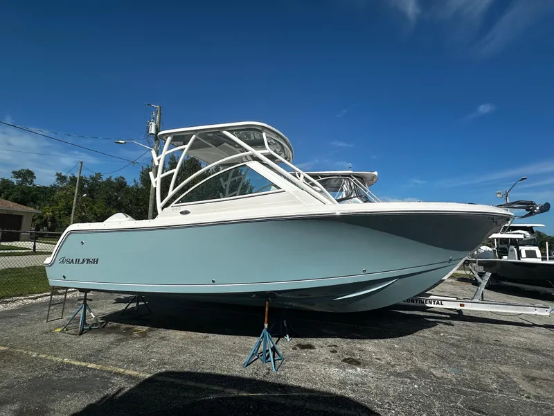 The Image of 2025 Sailfish 245 DC boat on stands in a parking lot. - 0