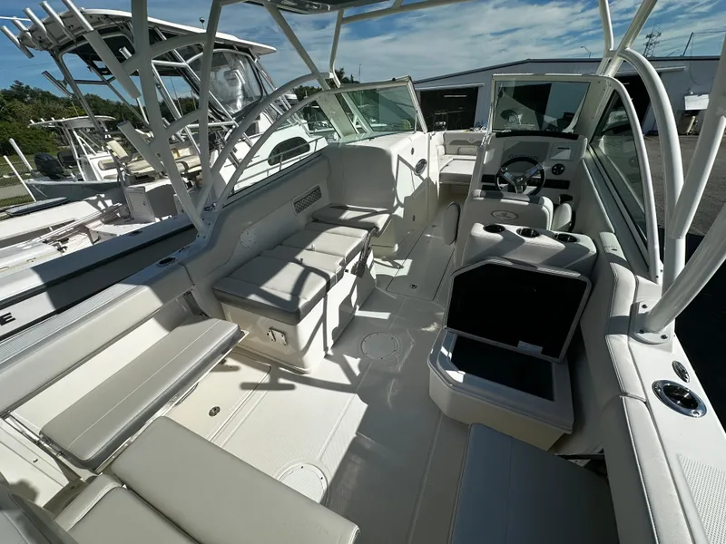 Slide: The Image of 2025 Sailfish 245 DC boat interior with seating and storage compartments. - 11