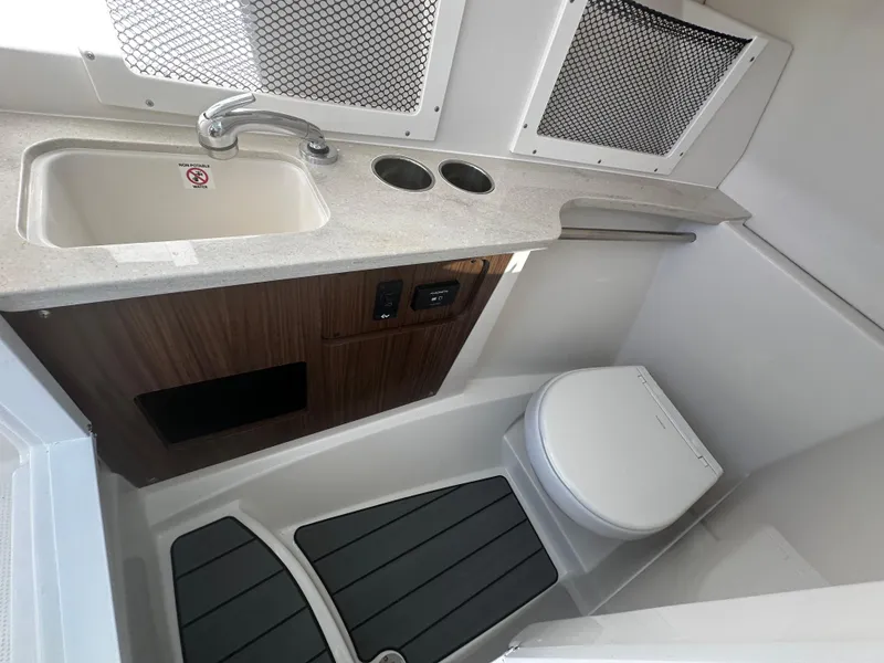 Slide: The Image of 2025 Sailfish 245 DC boat bathroom with sink and toilet. - 15