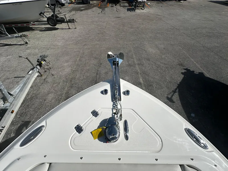 Slide: The Image of 2025 Sailfish 245 DC boat bow with anchor system in a marina. - 22