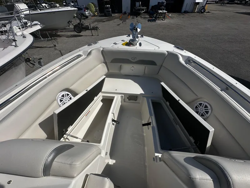 Slide: The Image of 2025 Sailfish 245 DC boat interior with open storage compartments. - 24
