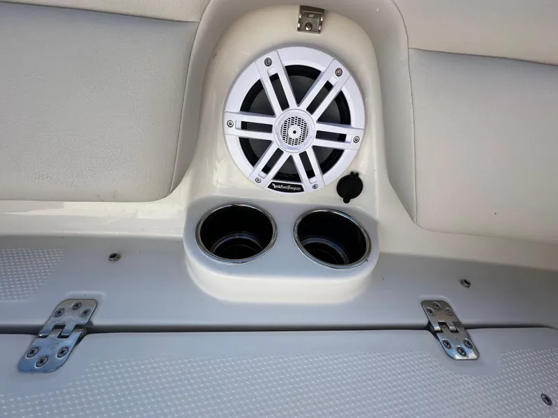 Slide: The Image of 2025 Sailfish 245 DC boat interior with speaker and cup holders. - 25