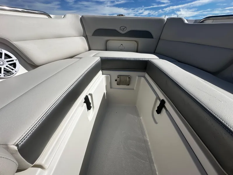 Slide: The Image of 2025 Sailfish 245 DC boat interior with cushioned seating and storage compartments. - 26