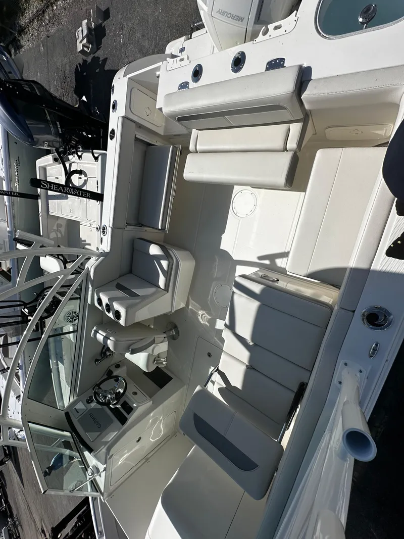 Slide: The Image of 2025 Sailfish 245 DC boat interior with seating and steering console. - 28