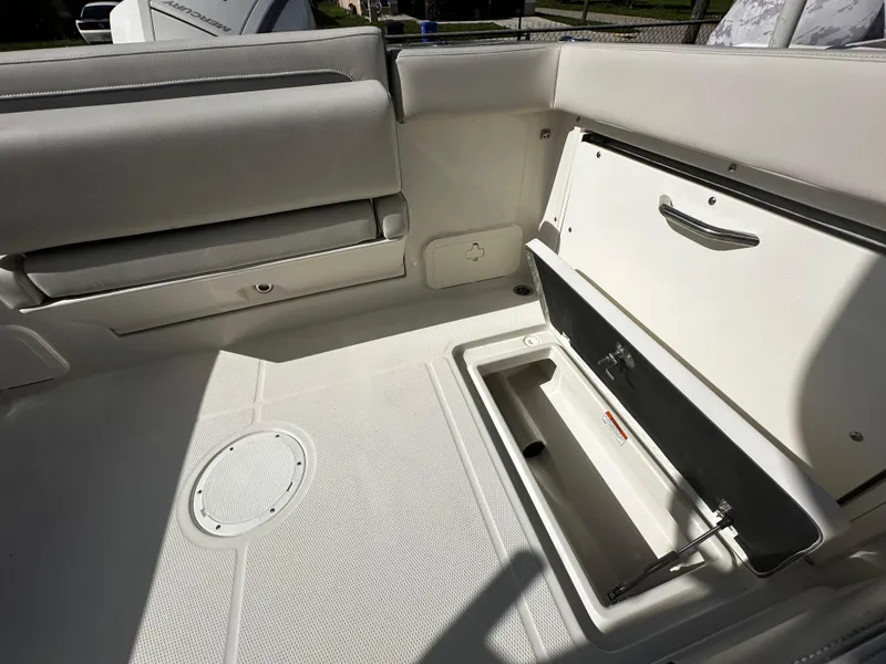 Slide: The Image of 2025 Sailfish 245 DC boat interior with storage compartments and seating. - 29
