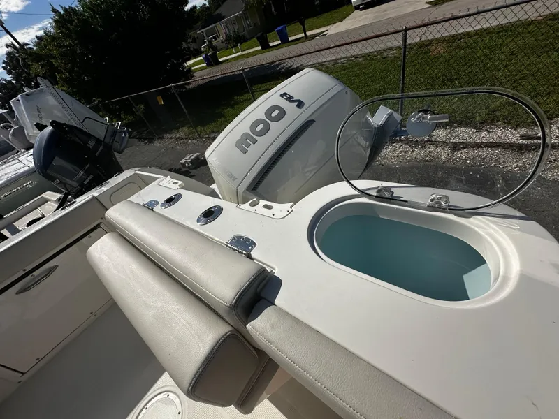 Slide: The Image of 2025 Sailfish 245 DC boat with outboard motor and seating area. - 30