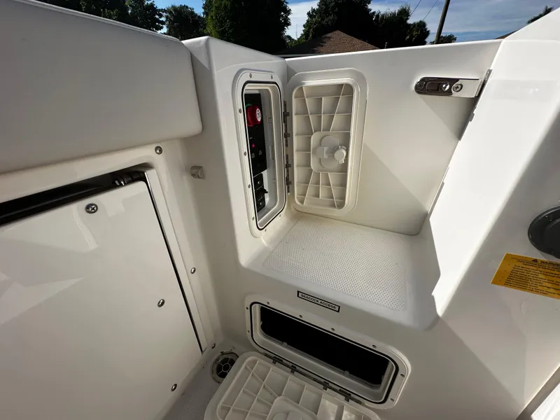 Slide: The Image of Interior view of the 2025 Sailfish 245 DC boat showing storage compartments. - 31