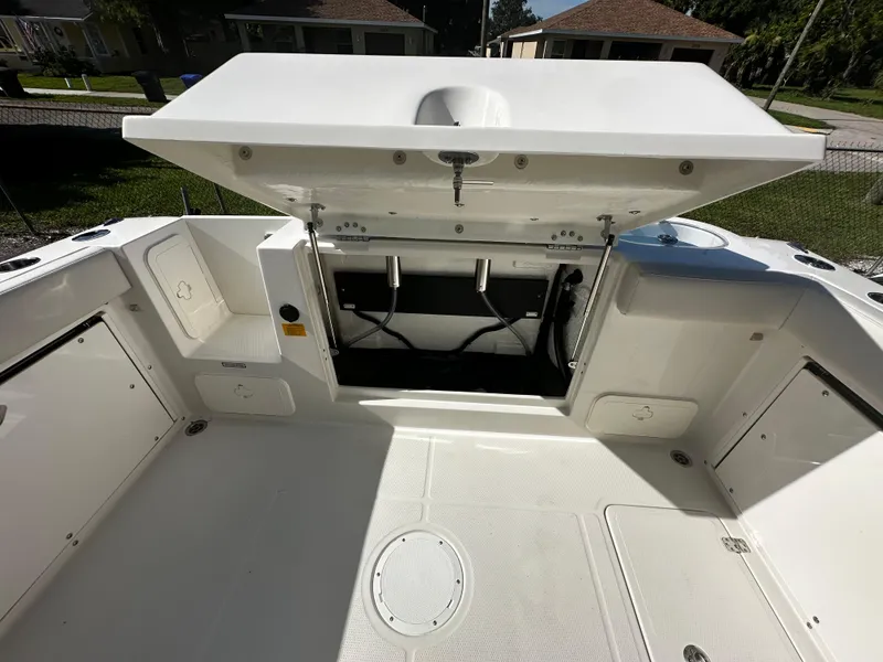 Slide: The Image of 2025 Sailfish 245 DC boat with open storage compartments. - 32