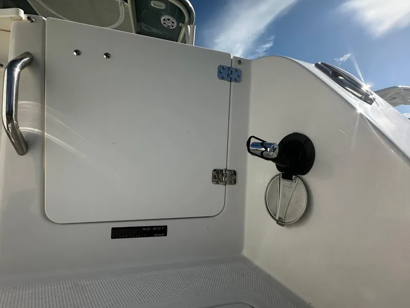 Slide: The Image of 2025 Sailfish 245 DC boat interior with storage compartment and handle. - 6