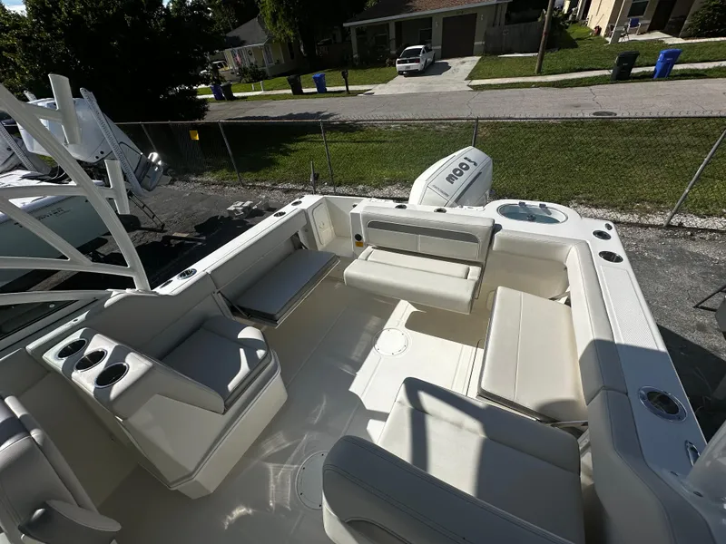Slide: The Image of 2025 Sailfish 245 DC boat interior with seating and Honda outboard motor. - 9