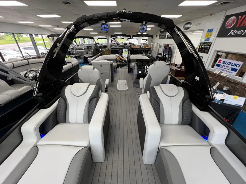 Slide: The Image of 2025 Godfrey Monaco 235 RL pontoon boat interior with luxurious seating in showroom. - 13