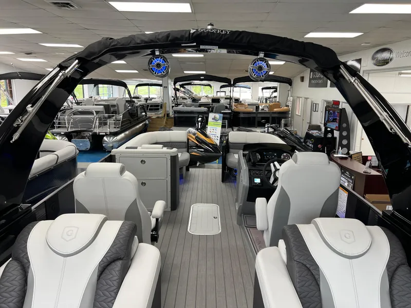 Slide: The Image of 2025 Godfrey Monaco 235 RL luxury pontoon boat interior with plush seating and modern amenities. - 15