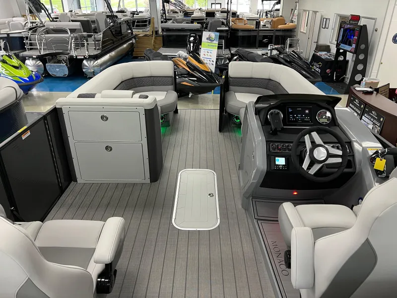 Slide: The Image of 2025 Godfrey Monaco 235 RL pontoon boat interior with modern seating and advanced helm controls. - 16