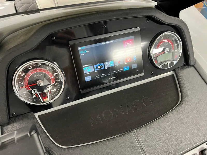 Slide: The Image of 2025 Godfrey Monaco 235 RL dashboard with digital display and gauges. - 19