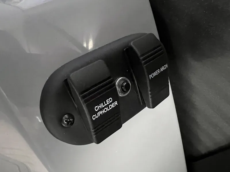 Slide: The Image of Control panel with chilled cupholder and power arch switches on 2025 Godfrey Monaco 235 RL. - 22