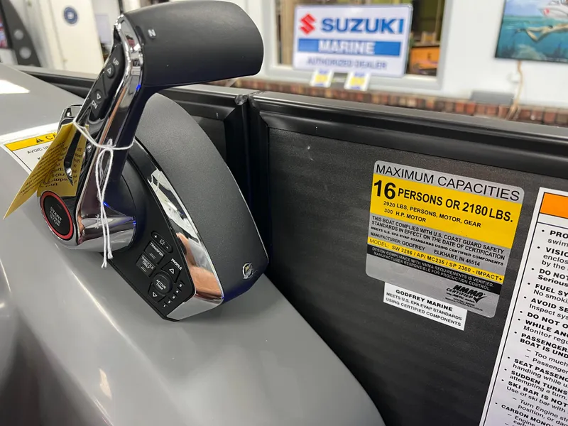 Slide: The Image of 2025 Godfrey Monaco 235 RL boat control panel and capacity label. - 23