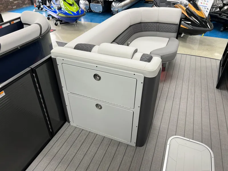 Slide: The Image of 2025 Godfrey Monaco 235 RL pontoon boat interior with gray seating and storage compartments. - 26