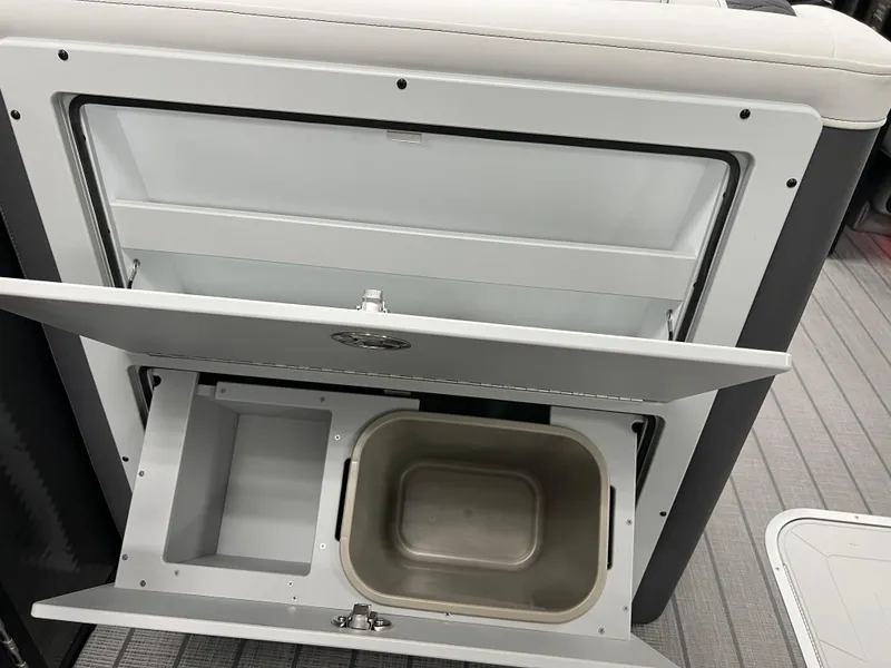 Slide: The Image of 2025 Godfrey Monaco 235 RL storage compartment with built-in sink and storage bins. - 27