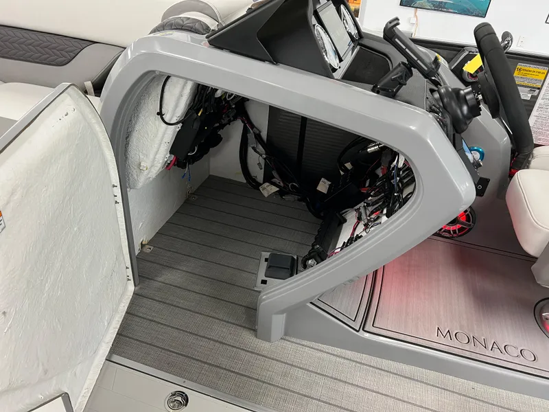 Slide: The Image of 2025 Godfrey Monaco 235 RL boat interior, showing helm station and seating area. - 28
