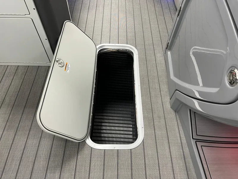Slide: The Image of Open storage compartment on the 2025 Godfrey Monaco 235 RL boat. - 29