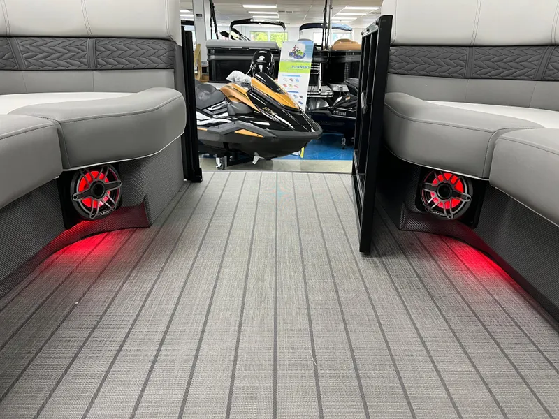 Slide: The Image of 2025 Godfrey Monaco 235 RL interior with red LED lighting and gray seating. - 31