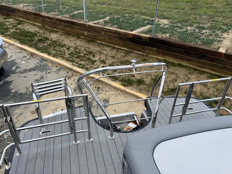 Slide: The Image of 2025 Godfrey Monaco 235 RL boat deck with stainless steel railing and ladder. - 16