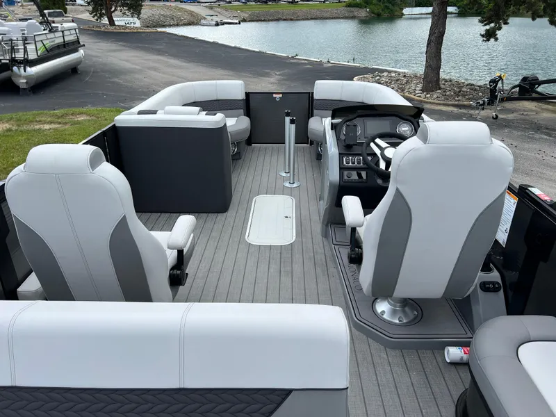 Slide: The Image of 2025 Godfrey Monaco 235 RL pontoon boat interior with gray seating and steering console. - 19