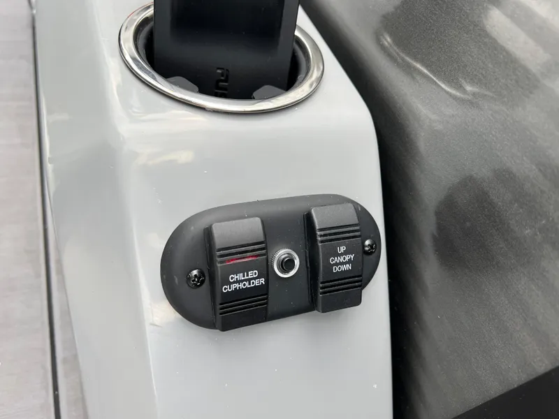 Slide: The Image of Control panel on 2025 Godfrey Monaco 235 RL with chilled cupholder and canopy switches. - 23