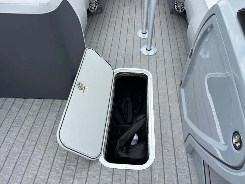 Slide: The Image of Open storage compartment on 2025 Godfrey Monaco 235 RL boat. - 25
