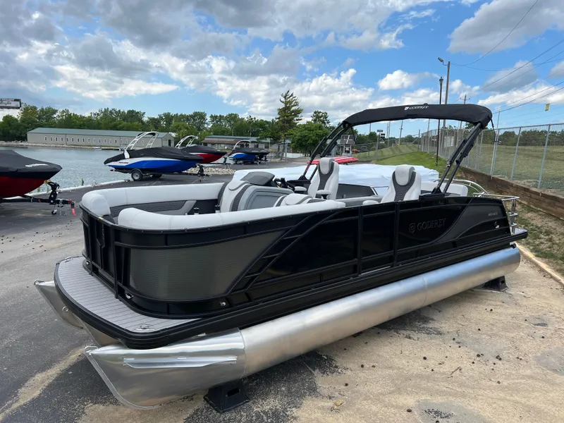 Slide: The Image of 2025 Godfrey Monaco 235 RL pontoon boat docked near a lake. - 4