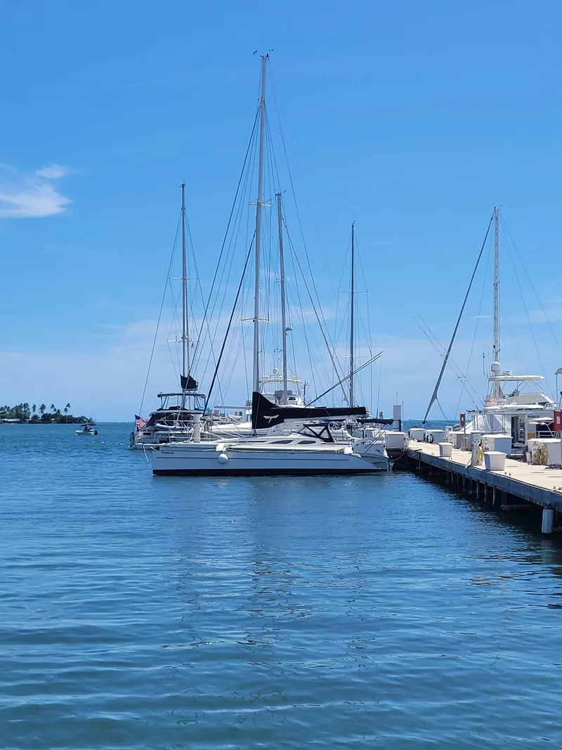 The Image of Sailboats docked at a marina under a clear blue sky, featuring a 2007 Dragonfly 35 Ultimate. - 0