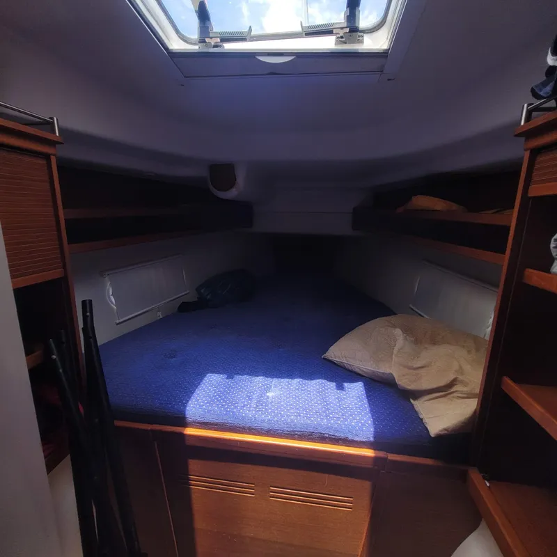 Slide: The Image of Cozy cabin interior of 2007 Dragonfly 35 Ultimate sailboat with skylight and blue bedding. - 4