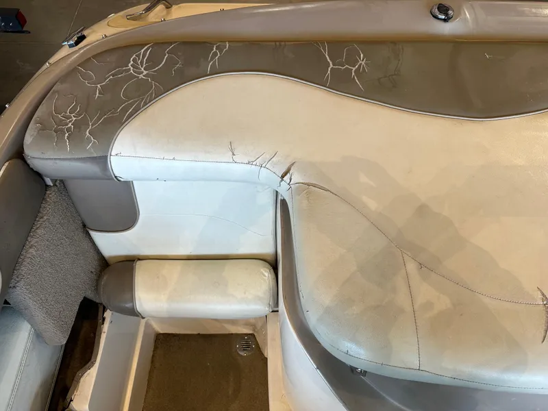 Slide: The Image of Worn interior seating of a 2001 Tahoe Q5 boat, showing cracked and aged upholstery. - 10