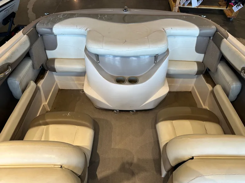 Slide: The Image of Interior of a 2001 Tahoe Q5 boat with beige and gray seating. - 12