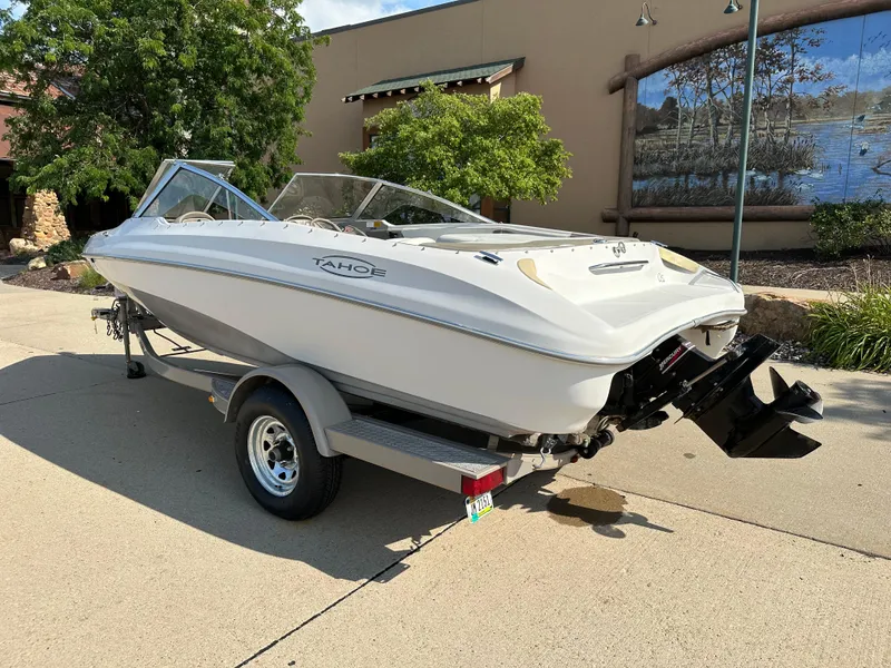 Slide: The Image of 2001 Tahoe Q5 boat on trailer, parked outdoors, sunny day. - 2