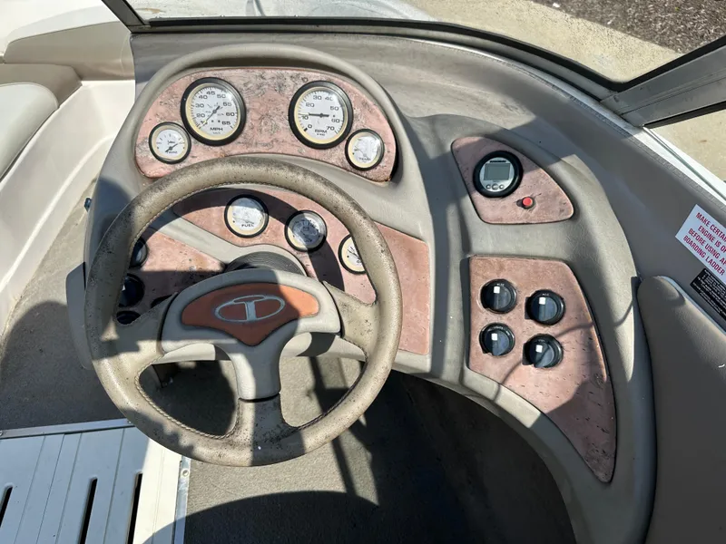 Slide: The Image of 2001 Tahoe Q5 boat dashboard with steering wheel and instrument gauges. - 4
