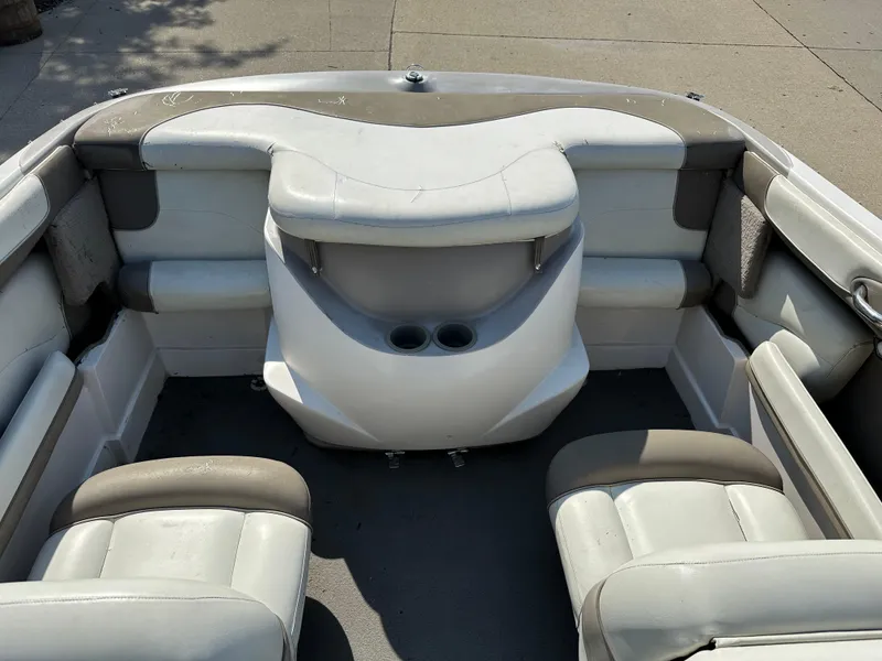 Slide: The Image of Interior of a 2001 Tahoe Q5 boat with white and gray seating. - 8