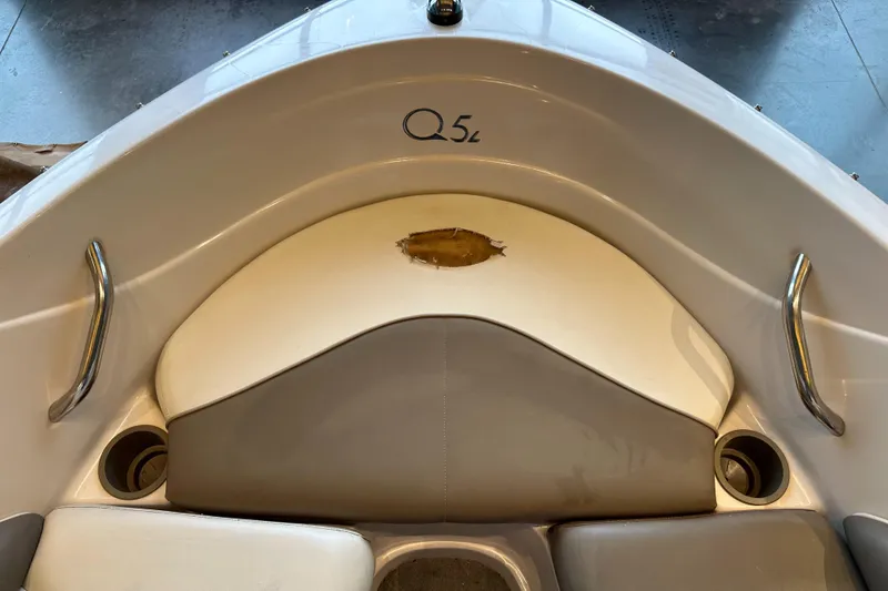 Slide: The Image of Front seating area of a 2001 Tahoe Q5 boat with cup holders and handles. - 9